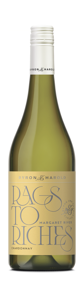 A Chardonnay wine bottle with a white cap and light yellow label with beautiful writing of Rags to Riches in dark grey for Byron & Harold wines.
