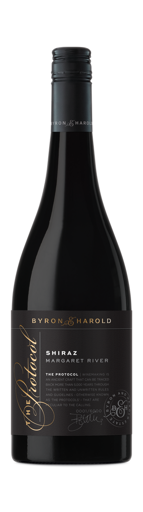 A Shiraz bottle from Margaret River with a black cap and black label with a beautiful cursive writing of The Protocol in gold for Byron & Harold wines.