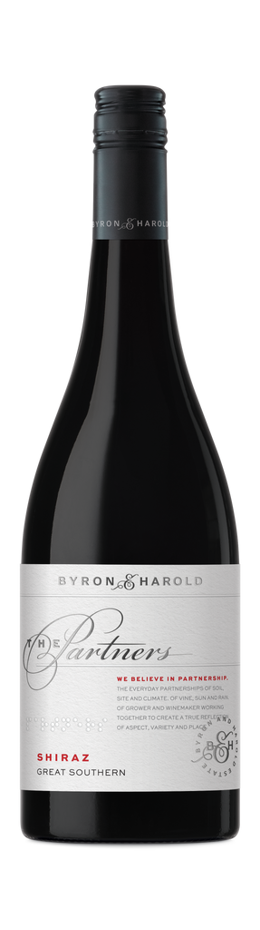 A Shiraz bottle from Great Southern with a black cap and white label with beautiful cursive writing of The Partners in black for Byron & Harold wines.
